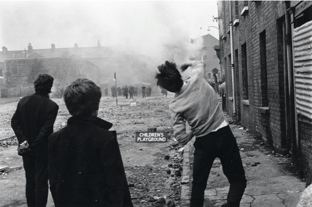 Youths throw stones at the Royal Ulster Constabulary in the Catholic Bogside area